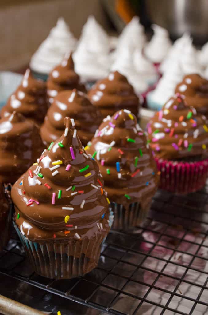 Freshly dipped Marshmallow High-Hat Cupcakes