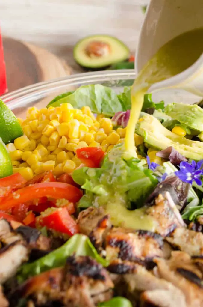 Southwestern Grilled Chicken Salad dressing is poured over freshly grilled chicken- The Goldilocks Kitchen