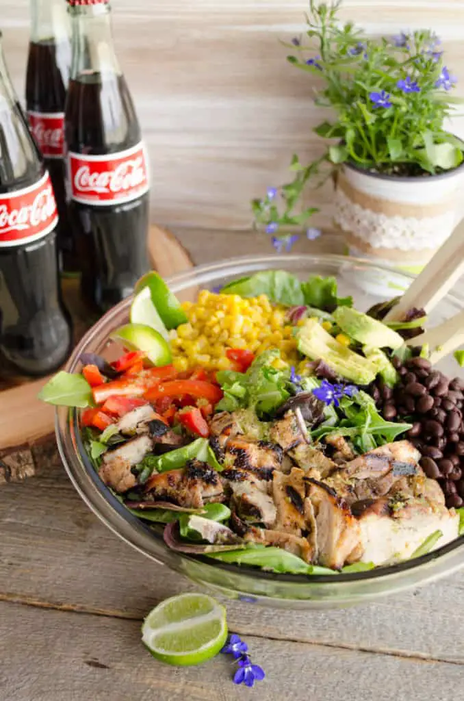 Southwestern Grilled Chicken Salad in a large bowl next to bottles of Coca-Cola - The Goldilocks Kitchen
