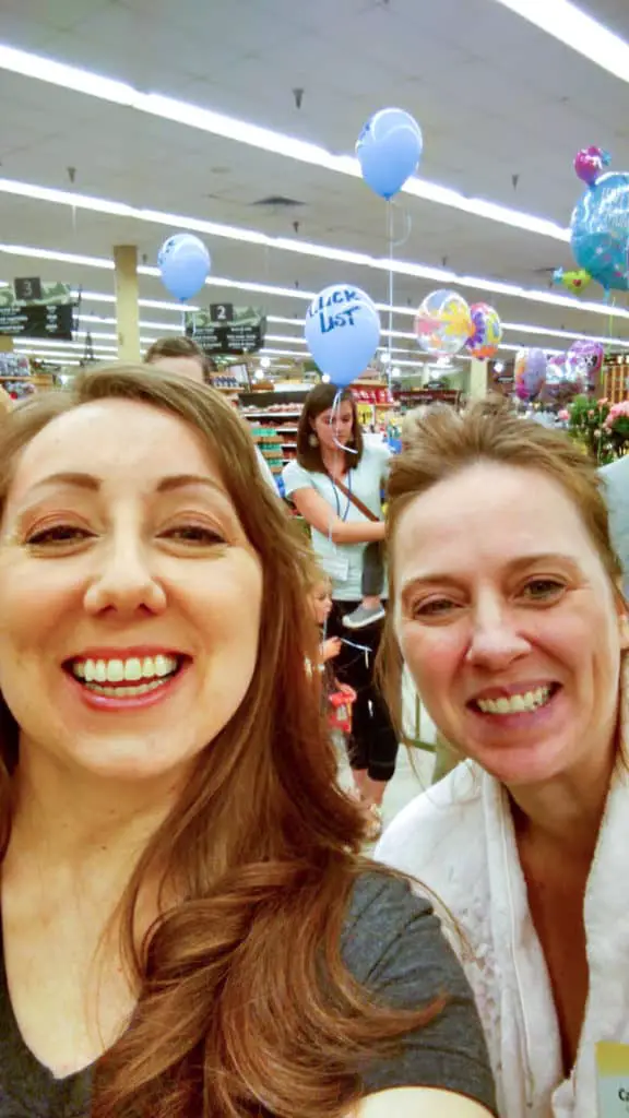 Two women pose for a selfie inside of Smith's Food and Drug for a Clicklist pajama party (with balloons in the background).