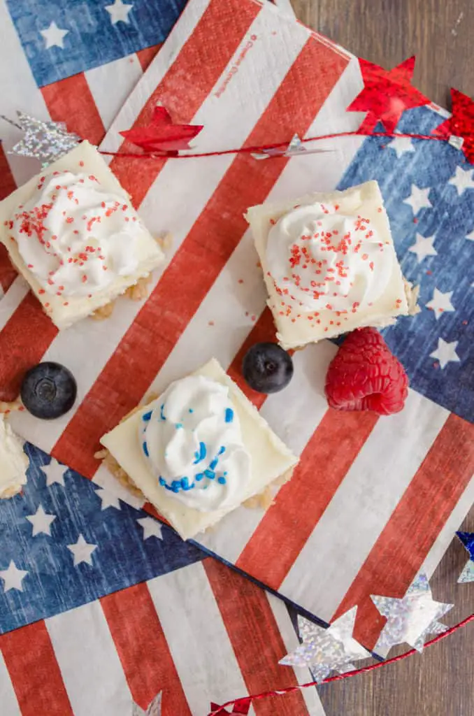 A top view of Creamy Crackle Cheesecake bars with sparkly stars and American flags