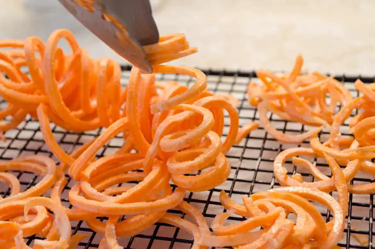 Sweet potato ringlets are about to be fried up into Crispy Southwestern Sweet Potato Fries.