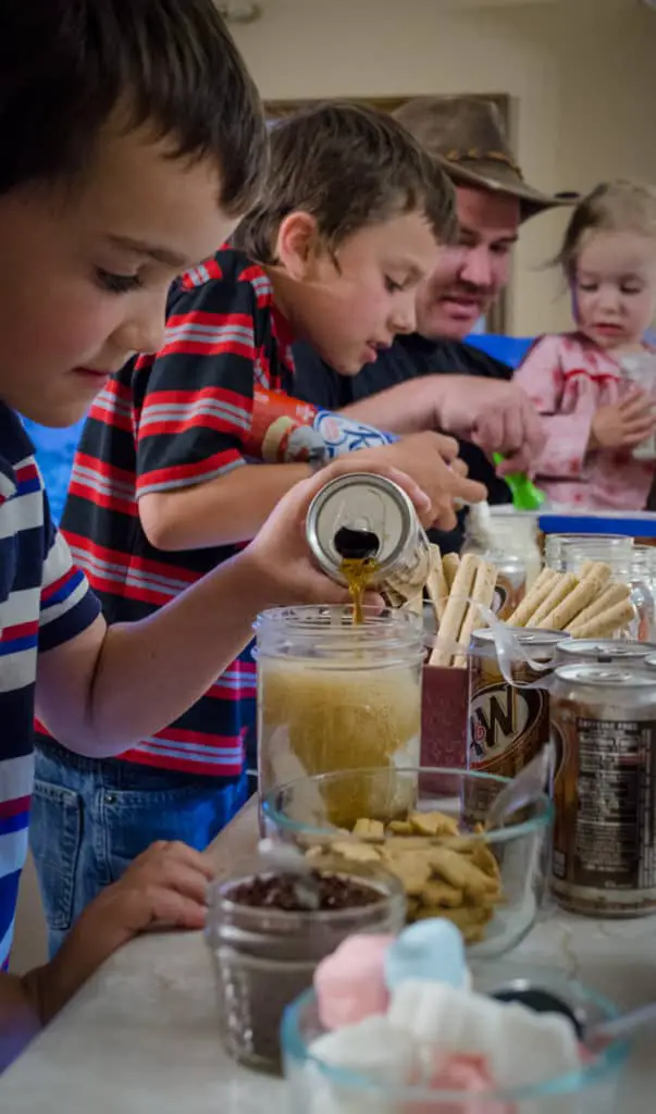 Children assemble their root beer floats for a Family Night Root Beer Float Bar.