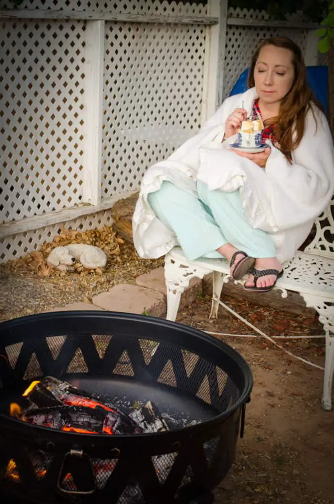 Emily enjoying her S'mores Cake with Roasted Marshmallows by the backyard campfire.