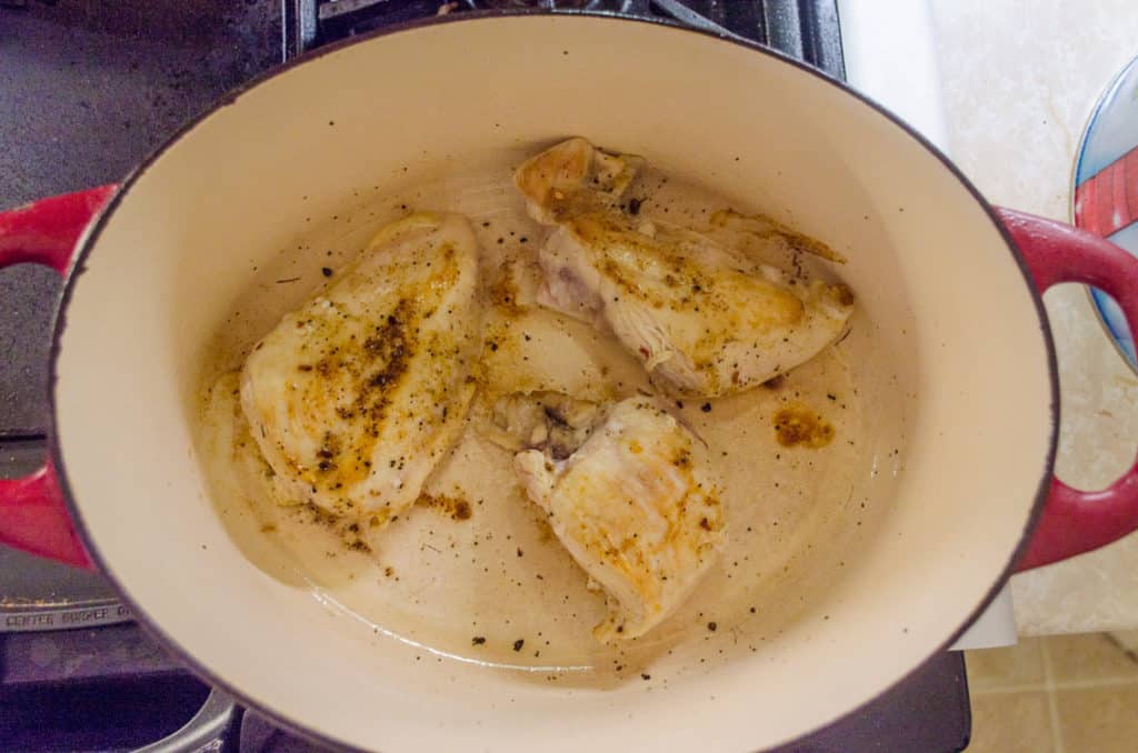 Boneless skinless chicken cooks in a stovetop dutch oven for Creamy White Chicken Chili.