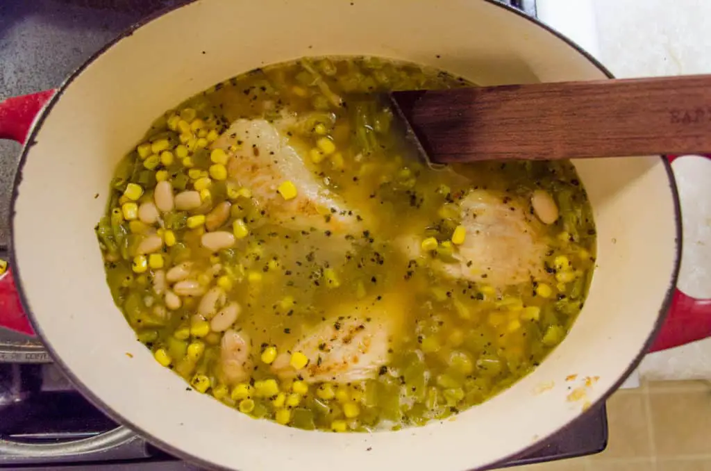 Creamy White Chicken Chili comes together by adding beans, chopped green chile, sweet corn and seasoned chicken breast to simmer in chicken broth.