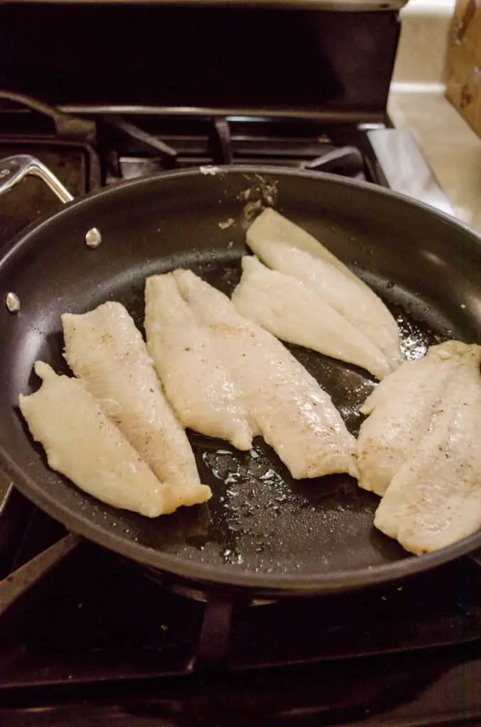 Fish frying in a non-stick frying pan for Fast Fish Dinner with Herbed Browned Butter recipe.