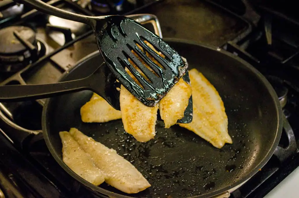 Flip fish for Fast Fish Dinner with Herbed Browned Butter by using two spatulas, on underneath and on on top to steady the fish and keep it from falling apart when flipped over.