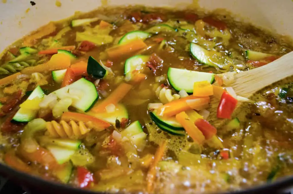 Vegetables, Rotini Pasta and sliced zucchini cook in Meatless Monday Vegetable Rotini Soup.