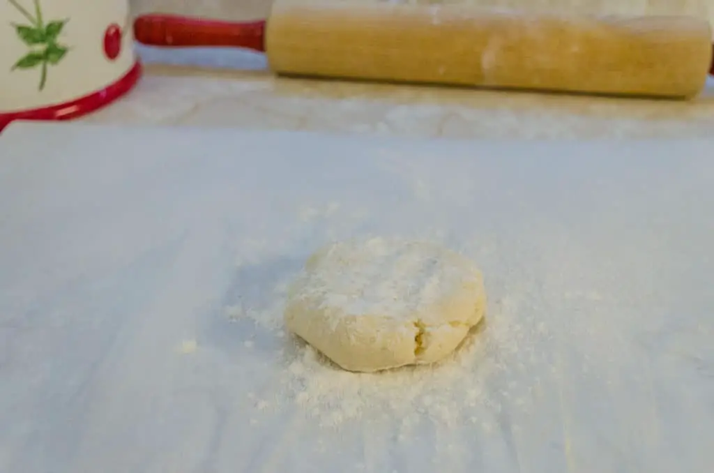 A flattened ball of dough sprinkled with flour for Norwegian Lefse - The Goldilocks Kitchen