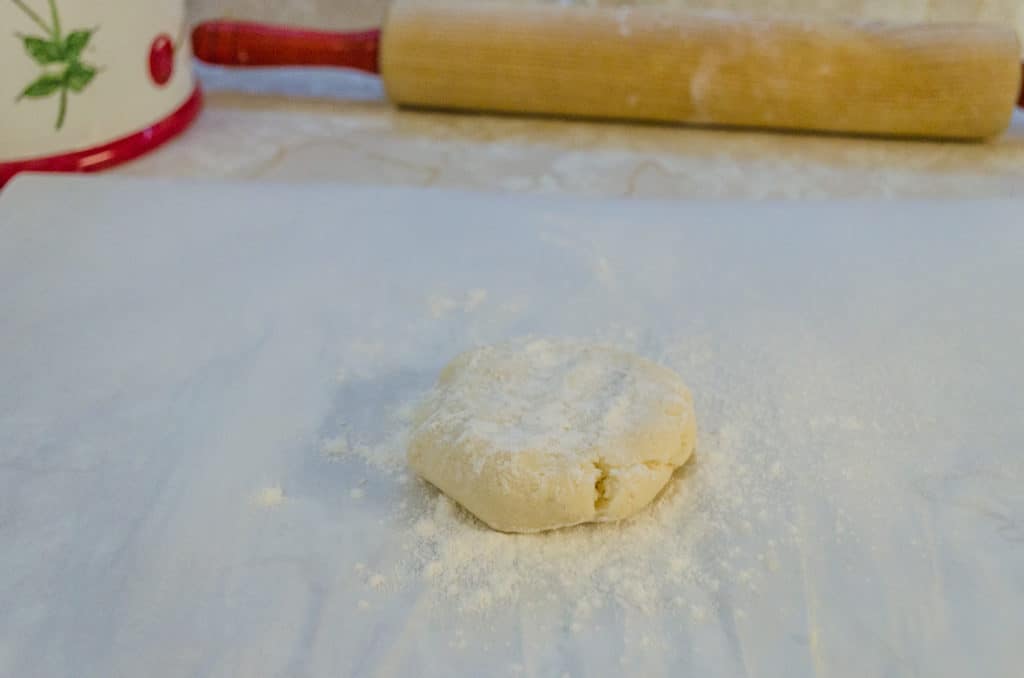 A flattened ball of dough sprinkled with flour for Norwegian Lefse - The Goldilocks Kitchen