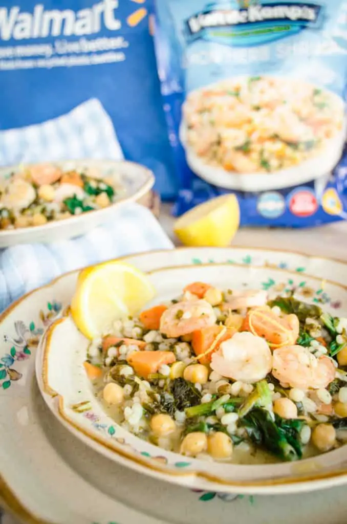 A plate of Van de Kamp's Seafood and Veggie Meals for Fish on Friday featuring Lemon Herb Shrimp with Chickpeas, Sweet Potatoes, and Spinach with a lemon wedge - The Goldilocks Kitchen