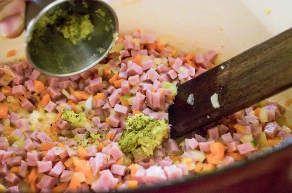 Pressed garlic, dried sage and dried oregano are added to diced ham, carrot and onion for Creamy Split Pea and Ham Soup. - The Goldilocks Kitchen