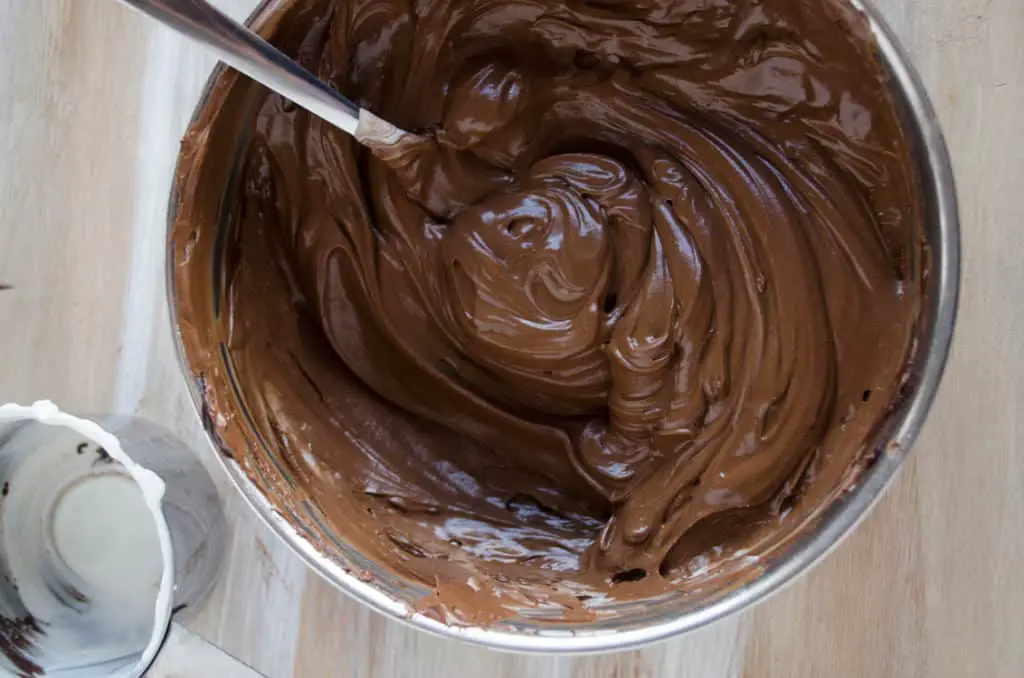A bowl of silky smooth melted chocolate is ready to be made into Chocolate Raspberry Bundt Cake. - The Goldilocks Kitchen