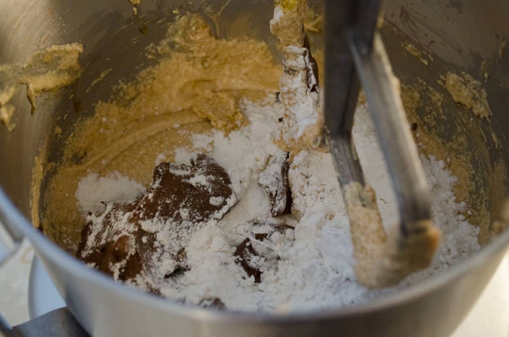 Chocolate and flour are added to a butter, egg, sugar mixture to make Chocolate Raspberry Bundt Cake. - The Goldilocks Kitchen