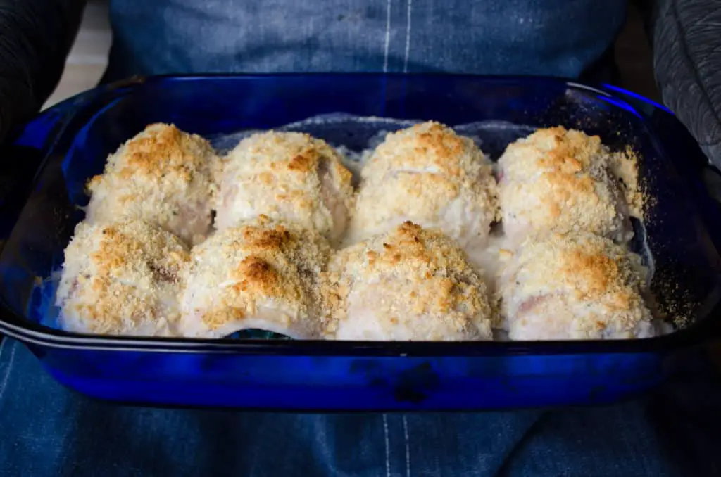 Creamy Stuffed Fish Florentine is presented in a transparent blue glass baking dish - The Goldilocks Kitchen 