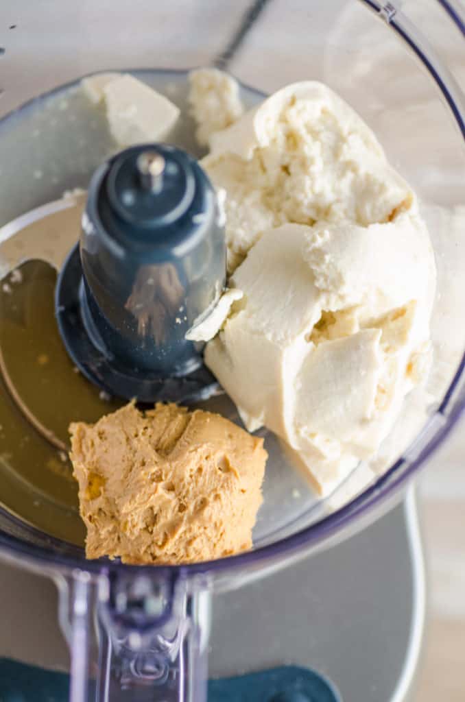 The bowl of a food processor containing tofu, peanut butter, lime juice and honey to make Silky Peanut Butter Dip. - The Goldilocks Kitchen