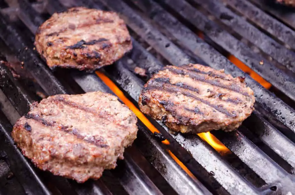 Meatloaf Burgers cook on a gas grill. 