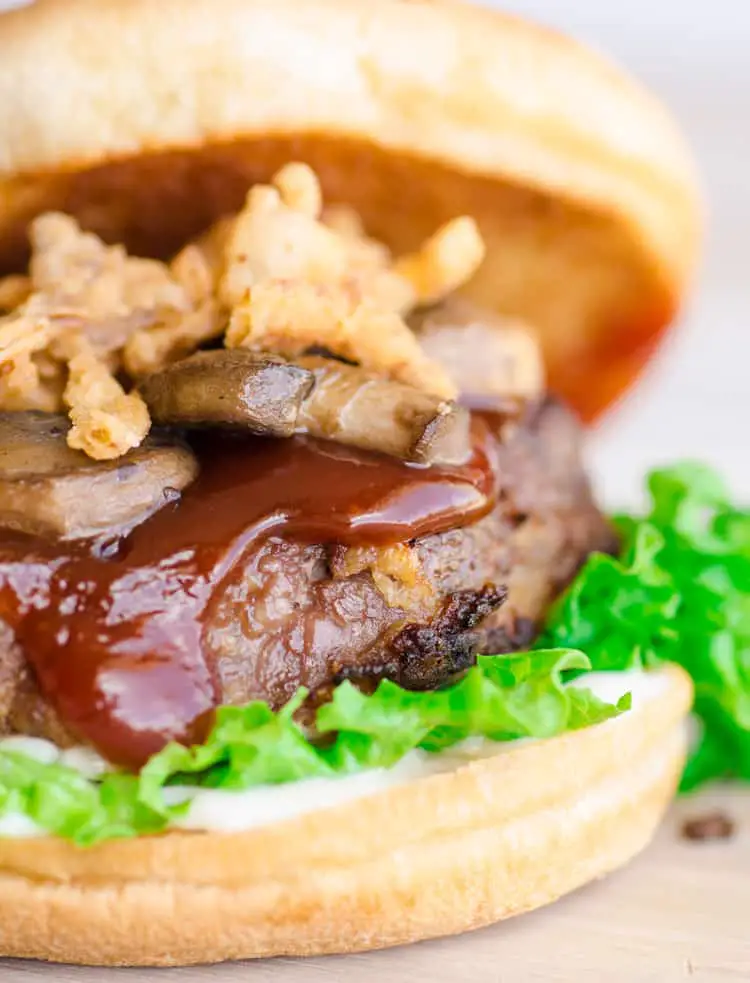 A Meatloaf burger is topped with sauteed mushrooms and french fried onions along with a special Meatloaf Burger Sauce.