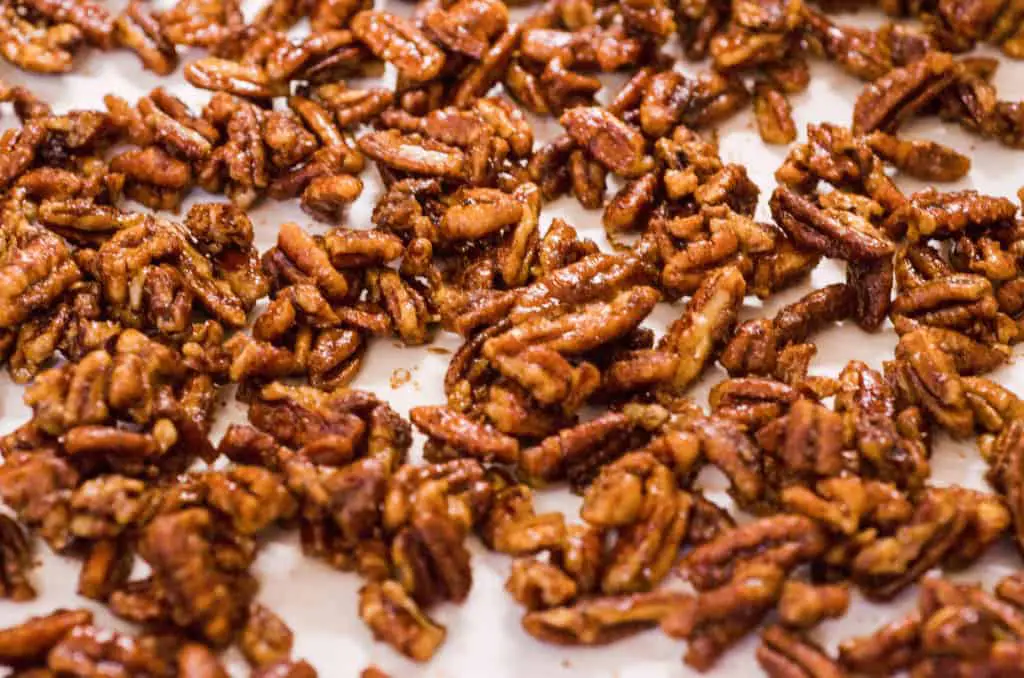Candied Spice Pecans cool on parchment paper - The Goldilocks Kitchen