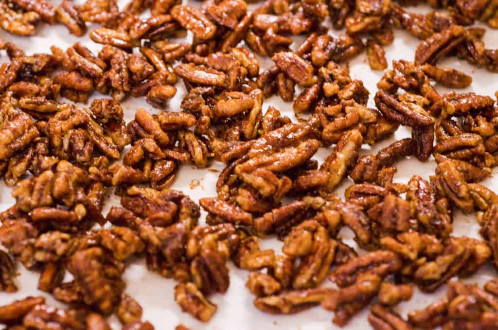 Candied Spice Pecans cool on parchment paper - The Goldilocks Kitchen