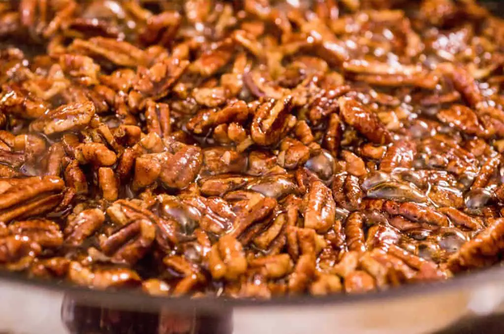 Candied Spice Pecans bubble and cook in a non-stick skillet - The Goldilocks Kitchen