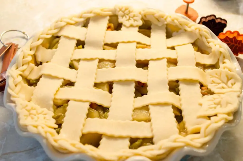 A lattice top is placed over Green Chile Apple Pie - The Goldilocks Kitchen