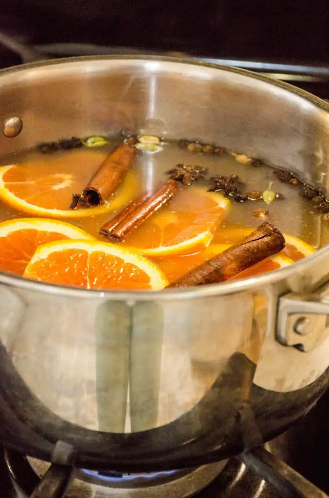 Mulled Apple Cider a.k.a. Wassail is cooked over a low flame in a large stainless steel stockpot.