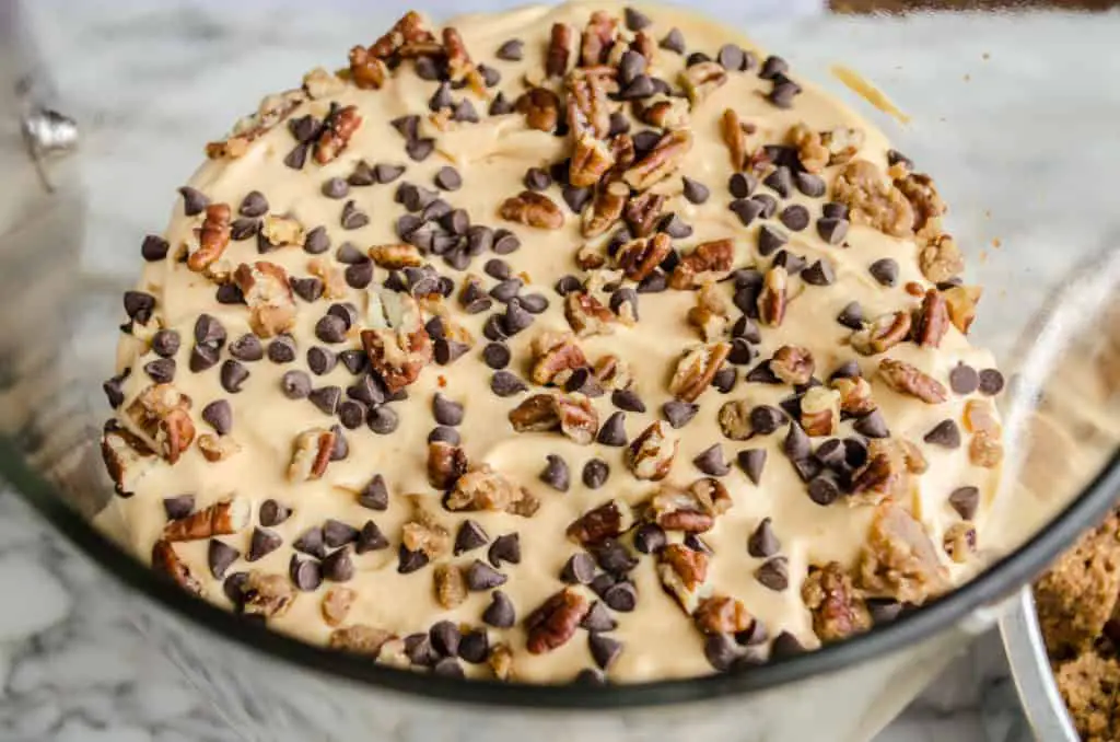 Pecan Pralines are sprinkled over pumpkin cheesecake pudding mix and chocolate chips for Pumpkin Spice Cheesecake Trifle - The Goldilocks Kitchen