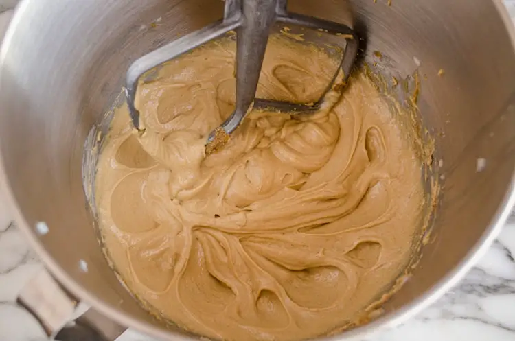 Peanut butter, butter and sugar are creamed together in a mixing bowl for Dove Peanut Butter Buttons cookies - The Goldilocks Kitchen