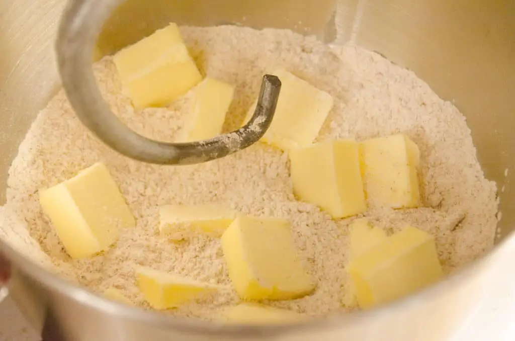 Cubes of butter are added to a flour and spice mixture to make Easy Gingerbread Cookies - The Goldilocks Kitchen