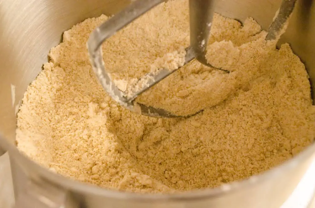 Butter and flour are beaten together to form a sandy looking mixture for Easy Gingerbread Cookies - The Goldilocks Kitchen