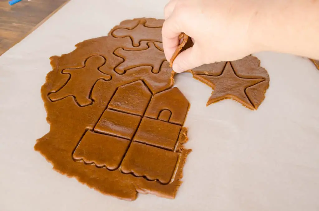 Excess Easy Gingerbread Cookies dough is peeled away from the cookie cutter shapes - The Goldilocks Kitchen