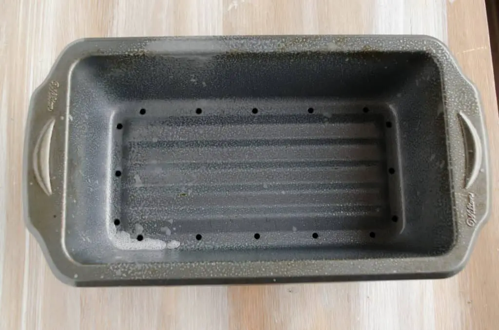 A picture of a meatloaf pan sprayed with non-stick cooking spray for Meatloaf - The Goldilocks Kitchen