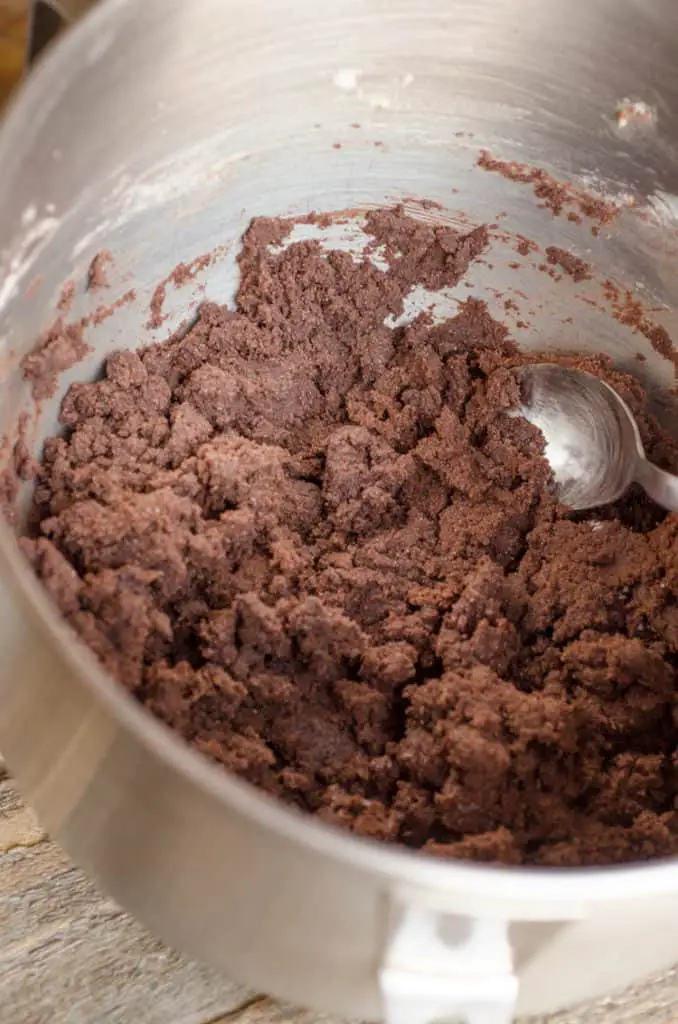 Chocolate cookie dough is seen in a mixing bowl, ready to be made into Homemade Oreo Cookies - The Goldilocks Kitchen