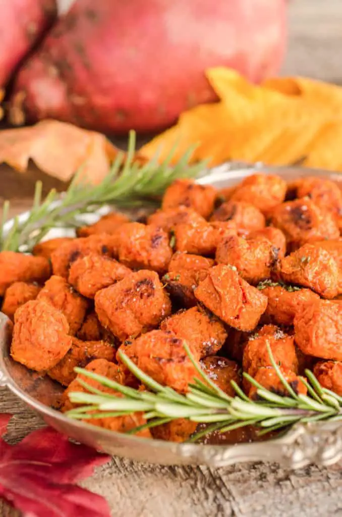 Several Sweet Potato Tater Tots sits on a silver tray garnished with rosemary sprigs - The Goldilocks Kitchen