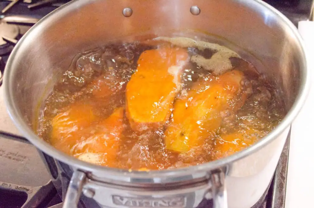 Sweet potatoes boil in a large stockpot to make Sweet Potato Tater Tots - The Goldilocks Kitchen