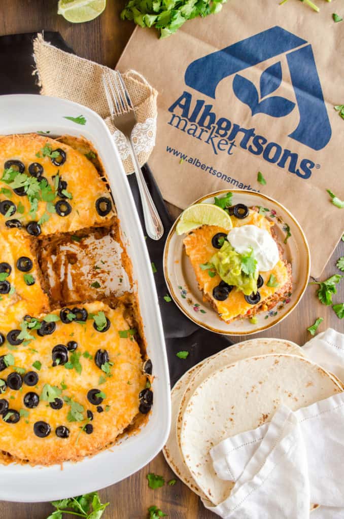 A white casserole dish with 30 Minute Mexican Lasagna and an Albertsons shopping bag - The Goldilocks Kitchen