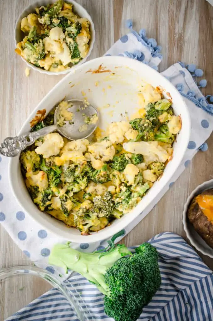 Looking down on a white casserole dish with Cheesy Cauliflower Broccoli Bake - The Goldilocks Kitchen