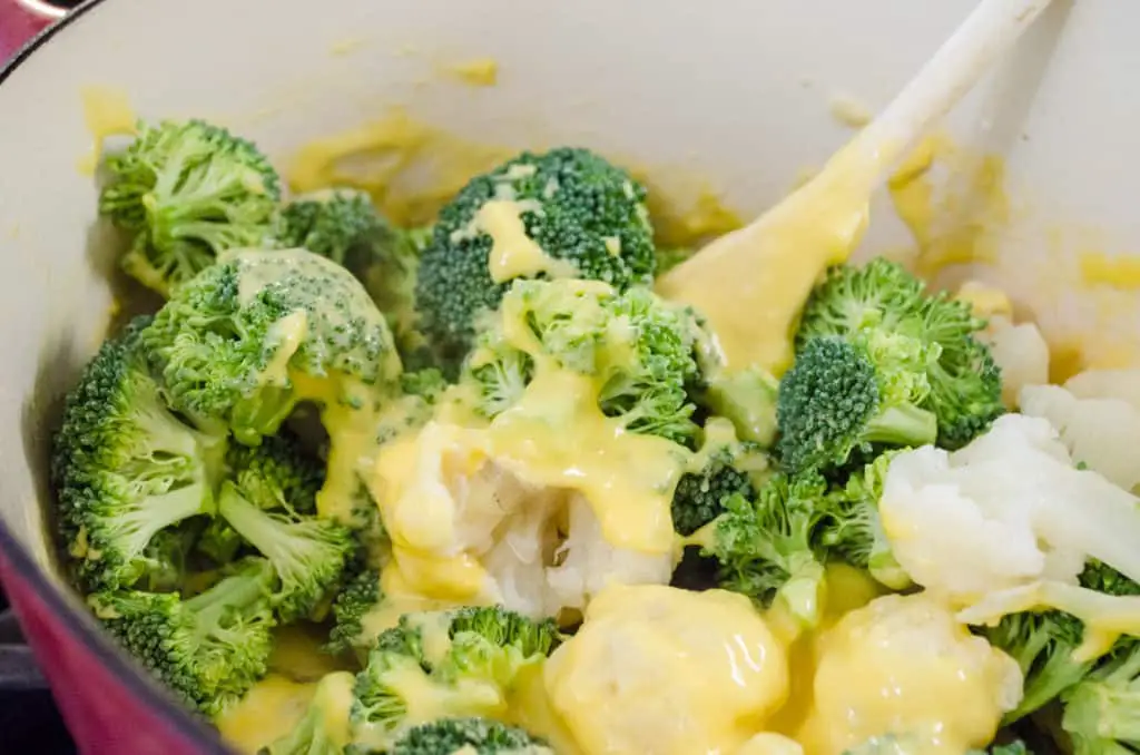 Cauliflower and broccoli florets are stirred into a cheesy sauce to make a Cheesy Cauliflower Broccoli Bake - The Goldilocks Kitchen