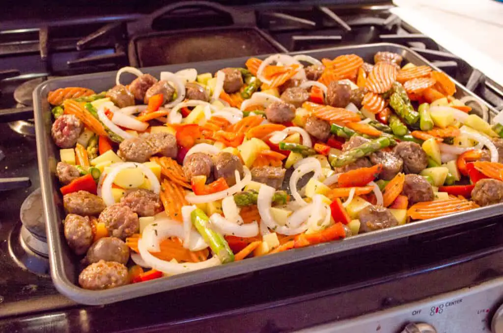 30 Minute Italian Sausage Sheet Pan Dinner sitting on the stovetop ready to be placed in the oven - The Goldilocks Kitchen