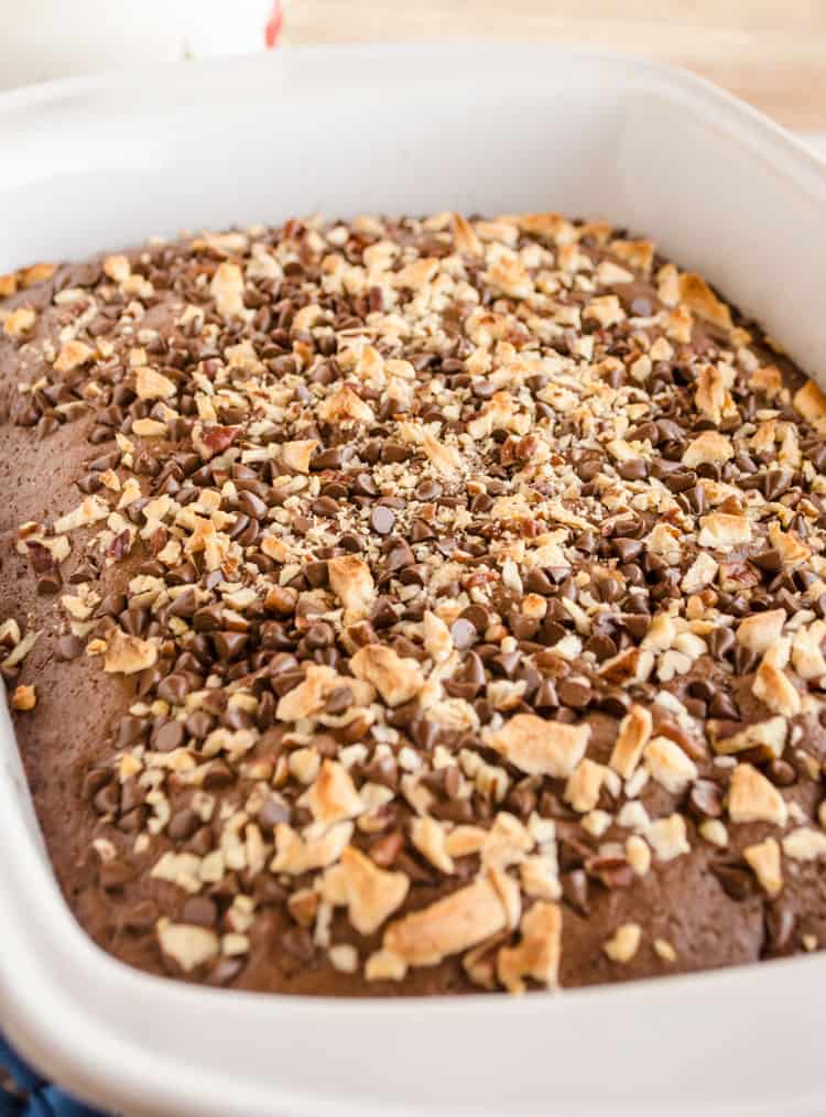 A freshly baked Applesauce Picnic Cake in a white baking dish - The Goldilocks Kitchen