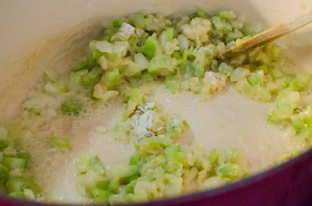 Diced cooked onion and celery is sprinkled with flour and stirred around to make the base for Chicken and Wild Rice Soup - The Goldilocks Kitchen