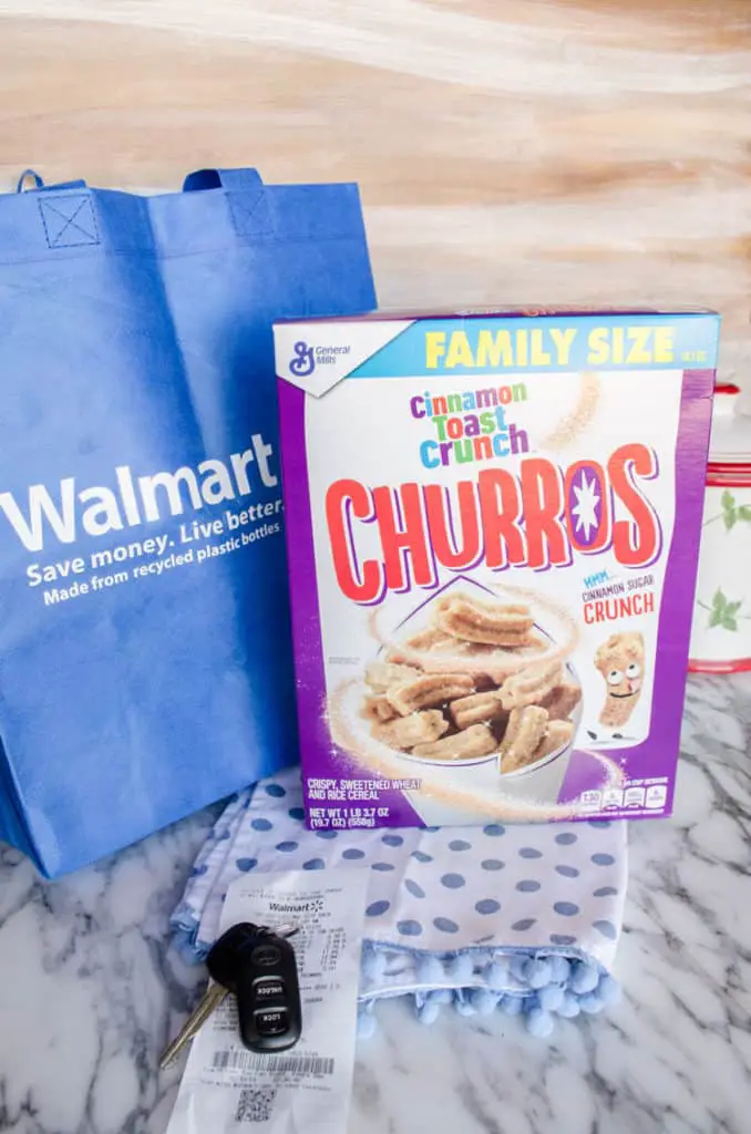 A blue Walmart shopping bag along with a box of new Cinnamon Toast Crunch Churros cereal used to make Churros Snack Mix - The Goldilocks Kitchen