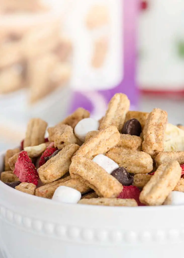 A close up of Churros Snack Mix in a white bowl- The Goldilocks Kitchen