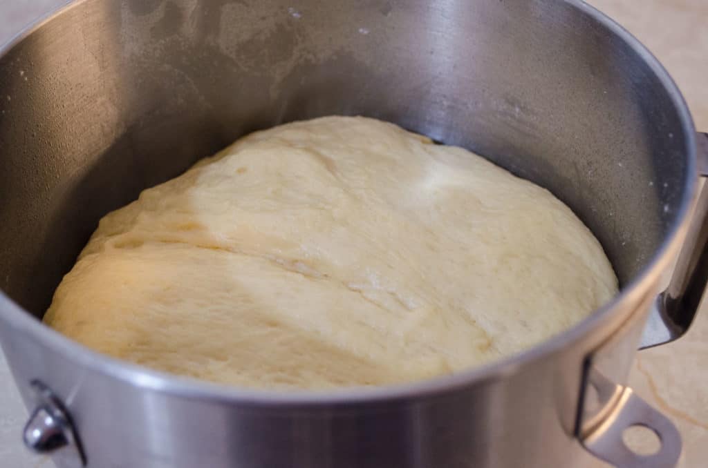 Fluffy risen dough in the bowl of a stand mixer for making Braided Challah Bread - The Goldilocks Kitchen