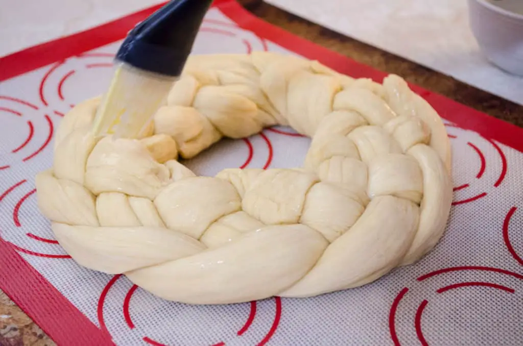 Braided challah dough is shaped in an optional circle and will bake into Braided Challah Bread - The Goldilocks Kitchen