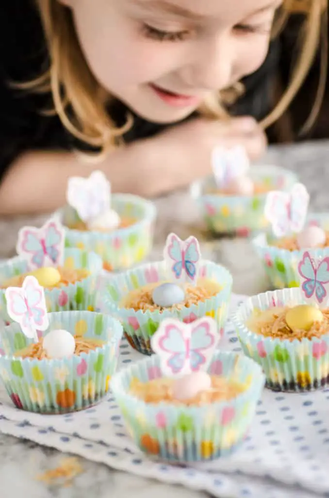  A young girl looks down on several Strawberry Mini-Cheesecakes decorated for Easter- The Goldilocks Kitchen
