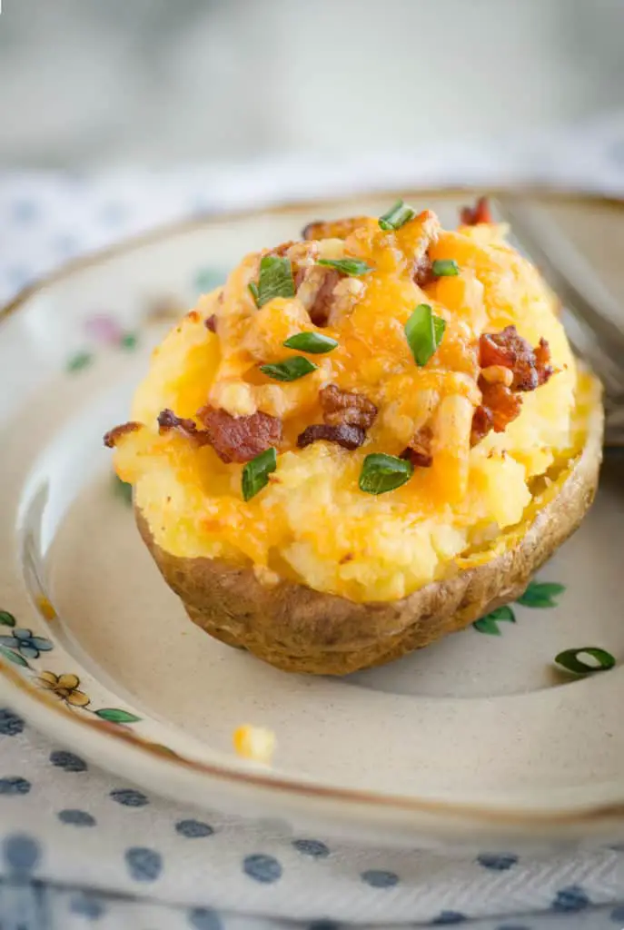 A freshly baked potato with toppings for the recipe Make Ahead Twice Baked Potatoes - The Goldilocks Kitchen