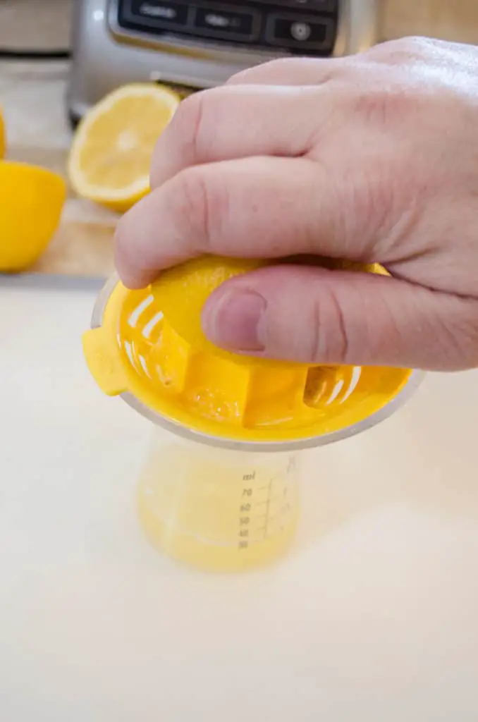 Juicing a sliced lemon to make a Lemonade Sparkler - The Goldilocks Kitchen